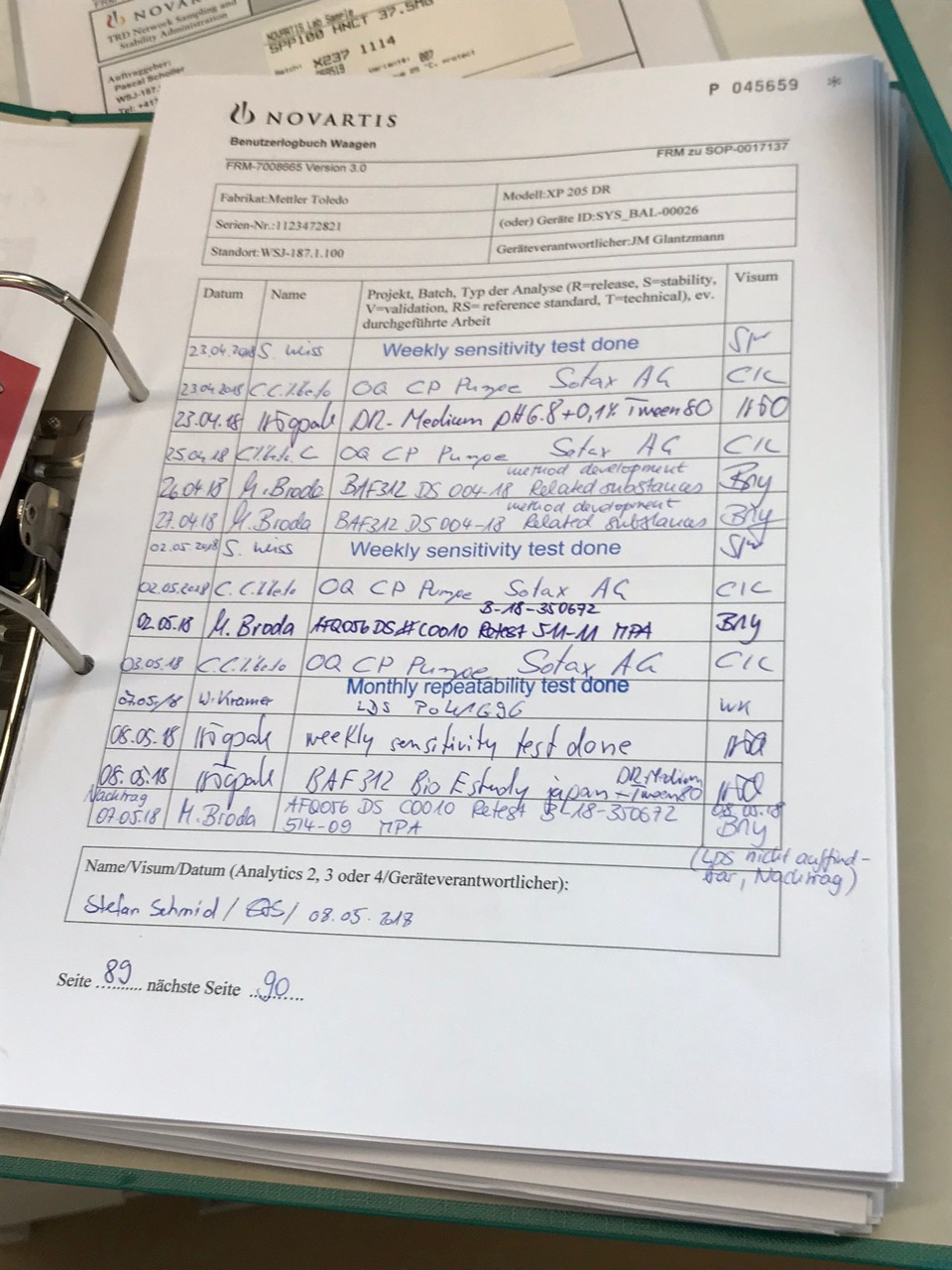 Second laboratory binder image showing paper-based documentation in the lab