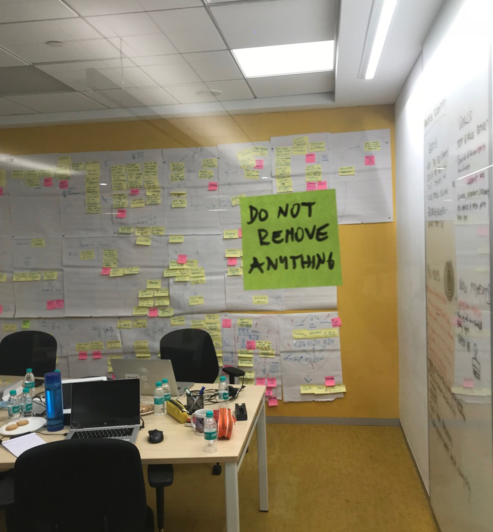 Discovery workshop wall with sketches, notes and clinical trial process mapping